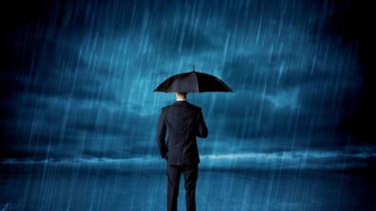 Business man standing in rain with an umbrella concept on background