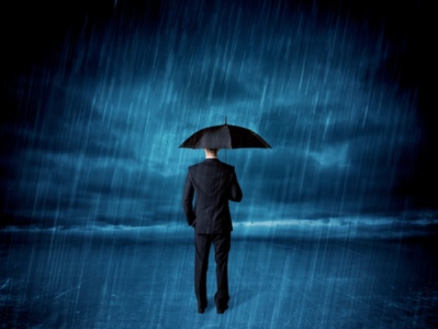 Business man standing in rain with an umbrella concept on background